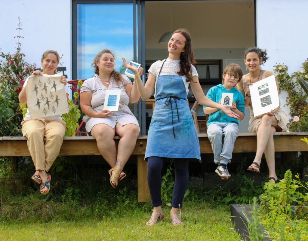 Participants à un atelier de linogravure présentant leurs créations